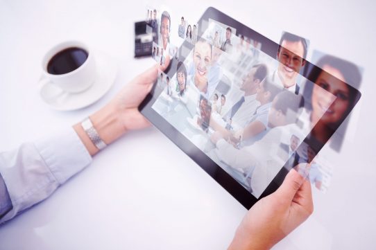 Man using tablet pc against group of business people brainstorming together